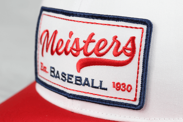 white and red baseball hat with embroidered patch